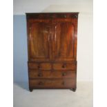 A Victorian flame mahogany linen press, four sliding drawers to top half and five drawers within the