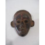 A small African clay mask - height 13cm