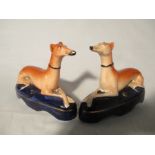 A pair of 19th century pen holders modelled as recumbent greyhounds