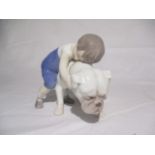 A Royal Copenhagen figurine of a child and dog