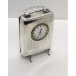 A hallmarked silver clock with carrying handle, Birmingham 1945