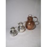 Two silver plated jugs and one copper jug