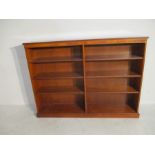 An oak veneered bookcase with six shelves H122cm L166cm D30cm