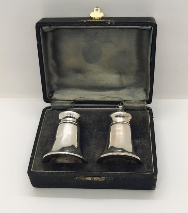 A cased hallmarked silver salt and pepper set