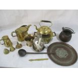 A collection of brassware including a lidded jug, watering can, mortar and pestle, warmer, bells