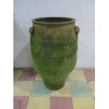 A large well weathered terracotta urn with three lug handles - height approx. 102cm