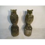 A pair of weathered concrete garden ornaments in the form of owls on granite plinths - overall