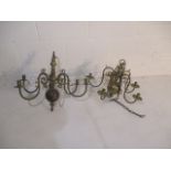 A six branch brass hanging ceiling light along with a five branch ceiling light