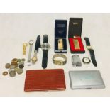 A collection of watches, lighters, cigarette cases and coins