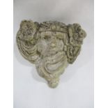 A concrete garden wall pocket in the form of an art nouveau lady