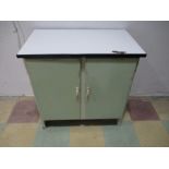 A mid century kitchen unit with enamel top