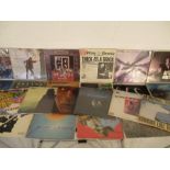 A collection of twenty five 12" vinyl records including Neil Young, Jethro Tull, Black Sabbath,