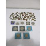 A collection of commemorative coins along with some loose