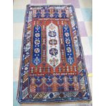 A Turkish handwoven red ground rug. 157cm x 88cm