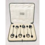 A cased set of Harrods hallmarked silver coffee bean spoons