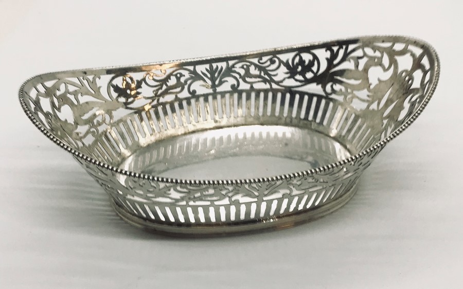 A continental silver basket with pierced rim decorated with birds