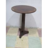 A Victorian mahogany table with a triangular base and hexagonal stem.