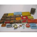 A collection of vintage tins along with an AA car badge