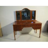 A vintage dressing table with mirror attached and four drawers