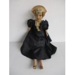 A 1940's doll in black dress