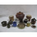 A collection of studio pottery including lidded storage jars, small jugs, dish etc