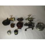 A collection of eight fishing reels including shimano, Shakespeare etc