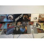 A collection of 12" vinyl records including Pink Floyd, Bad Company, Rolling Stones, Santana,