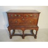 An 18th century walnut chest on stand (Circa 1720), the top with quarter veneer and cross banding in