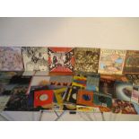 A collection of 12" vinyl records including The Beatles, Lynyrd Skynyrd, Meat Loaf, Paul