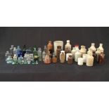A collection of glass bottles and stoneware jars