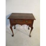 A George II oak lowboy with single drawer over shaped frieze