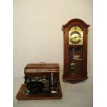 A vintage Frister and Rossmann electric sewing machine and an AMS wall clock