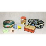 A collection of vintage tins and novelty egg cups