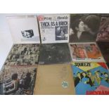 A collection of 12" vinyl records including The Rolling Stones, Fleetwood Mac, Jethro Tull, Free,