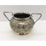 A hallmarked silver two handled sugar bowl with embossed floral decoration