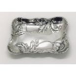 A hallmarked silver pin tray decorated with poppies