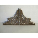 A pair of large cast iron decorative wall brackets