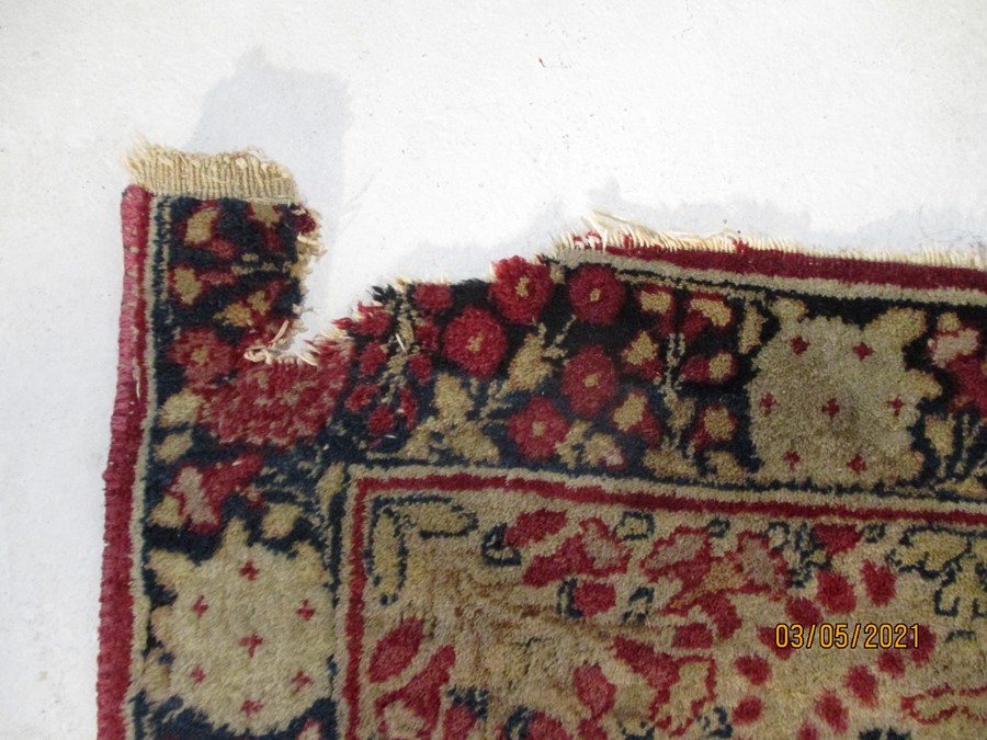 A red ground rug with floral decoration, 7 ft 2" x 4 ft 9 "- some damage to edges - Image 6 of 8