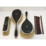Three silver and tortoiseshell brushes along with a comb