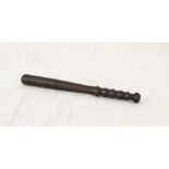 A wooden truncheon with turned handle