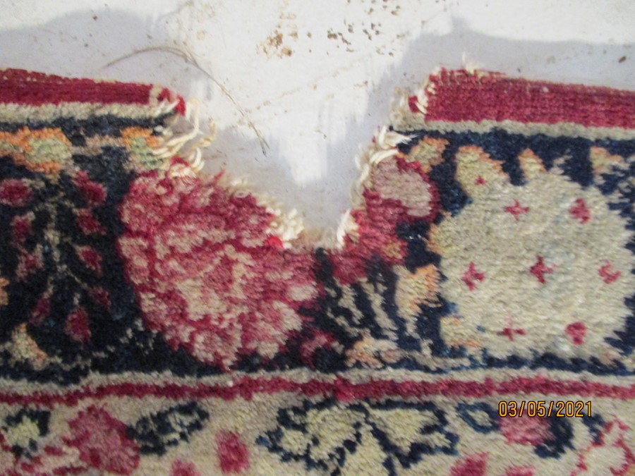 A red ground rug with floral decoration, 7 ft 2" x 4 ft 9 "- some damage to edges - Image 8 of 8