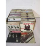 A large collection of 7" vinyl records including The Beatles, Elvis Presley, Queen, David Bowie,