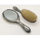 A hallmarked silver dressing table mirror with matching hair brush