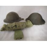 Two British military helmets plus a webbing pouch