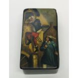 An antique papermache snuff box, the top with handpainted comedic scene