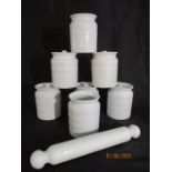 A collection of 7 vintage storage jars ( 1 no lid) along with a pottery rolling pin