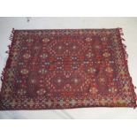 A red ground rug/wall hanging, approx. 7 ft x 5 ft