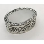 A hallmarked silver pill box, oval with impressed decoration
