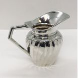 A small hallmarked silver cream jug, weight 82.6g