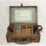 A leather bound cartridge case with retailers label "Army & Navy Co-Operative Society Ltd" and